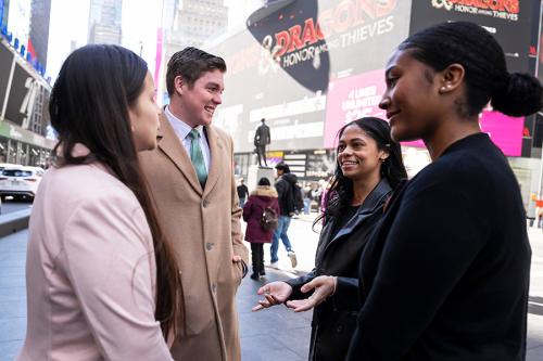 Students talk and smile in Times Square.