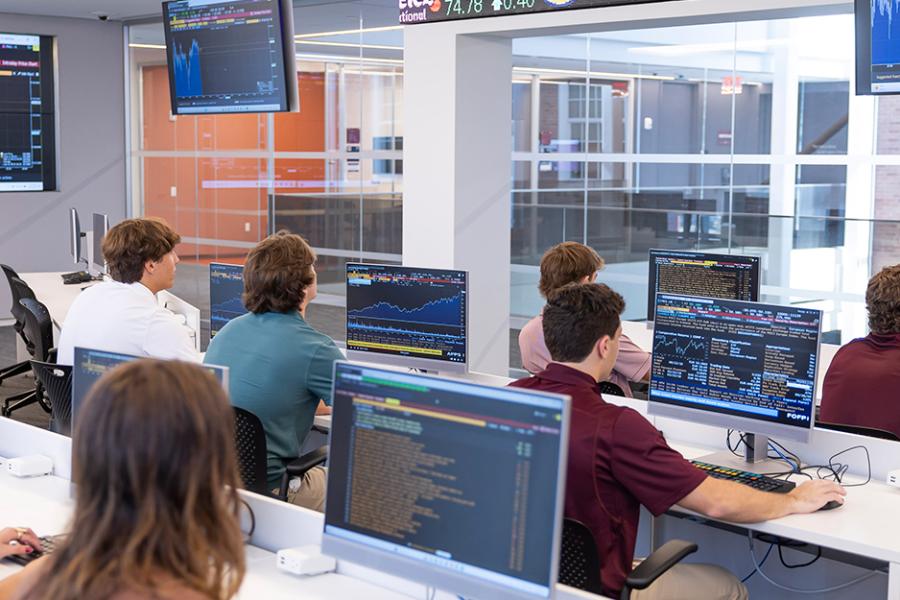 Students learn about risk management in trading room.