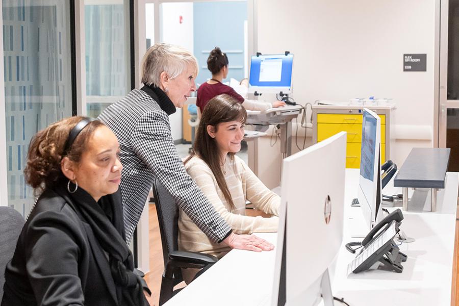 A professor working with students in the Kelly Center.