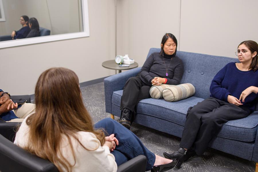 Therapists work with a family in the MFT clinic room.