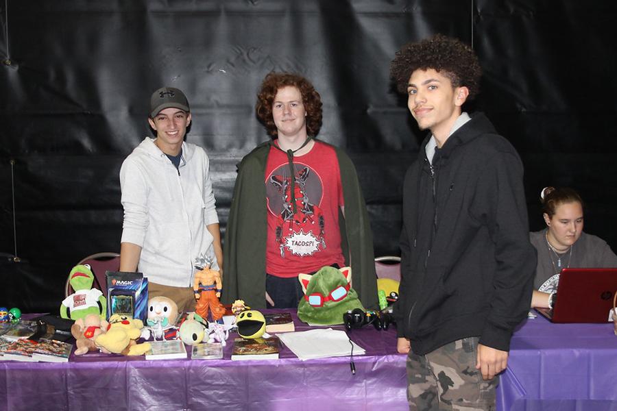 Two members of the Admirers of Illustrated Literature club recruit a new member at the involvement fair.