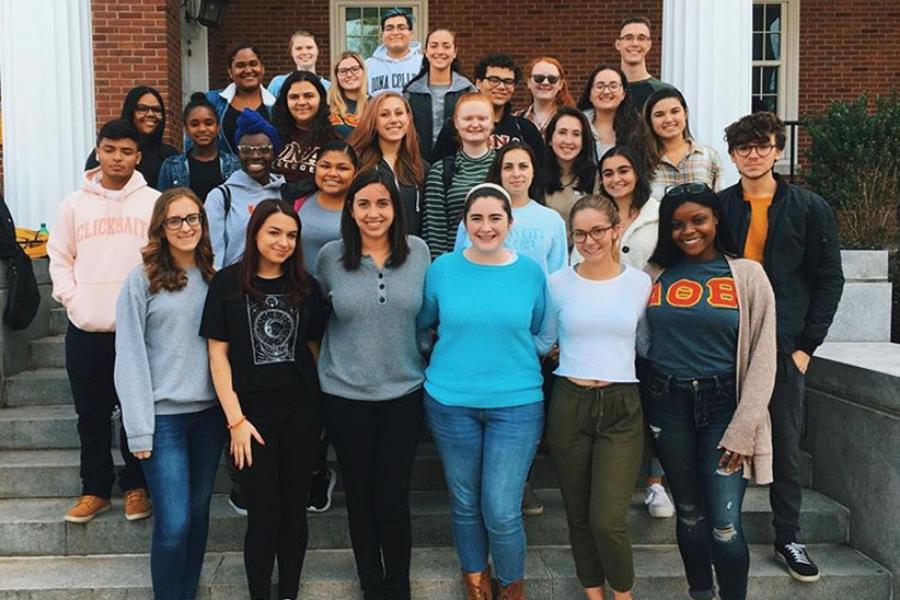 American Sign Language Club members stand outside in front of Spellman.