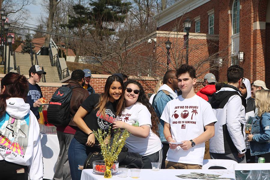 Students at the involvement fair smile and promote alcohol awareness using mocktails.