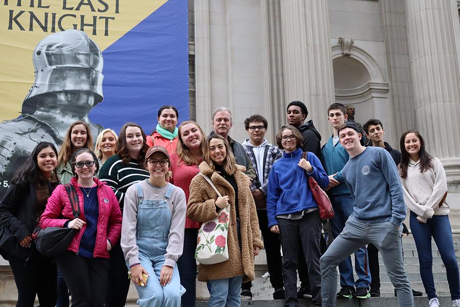 Members of the honors program meet a museum in New York City.