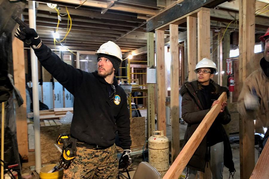 Cody Kiefer works on a house as part of a volunteer crew.