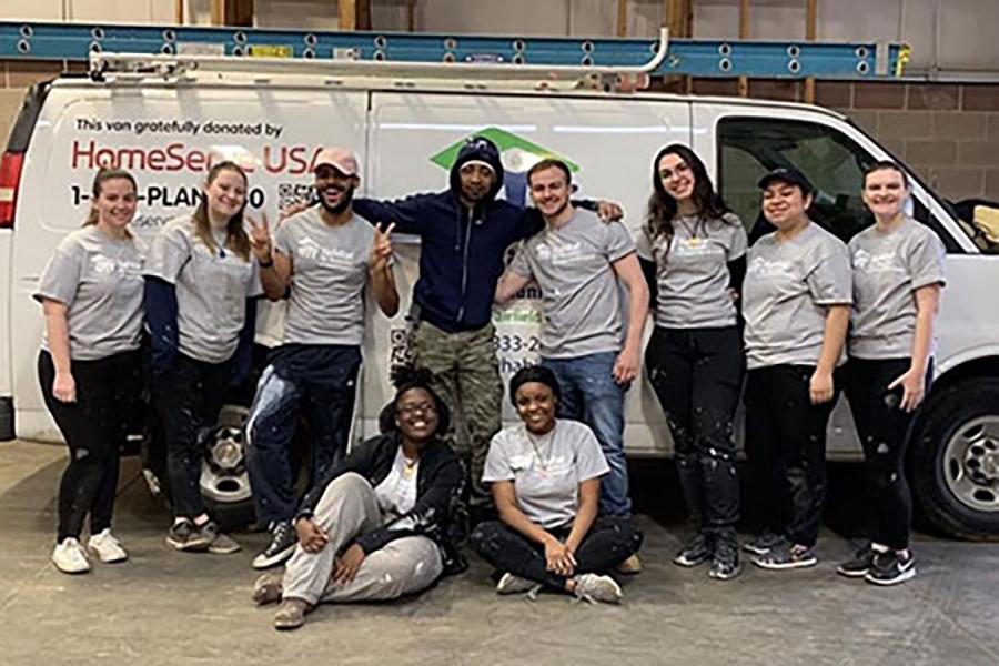 Students stand in front of a truck for the Habitat for Humanity trip.