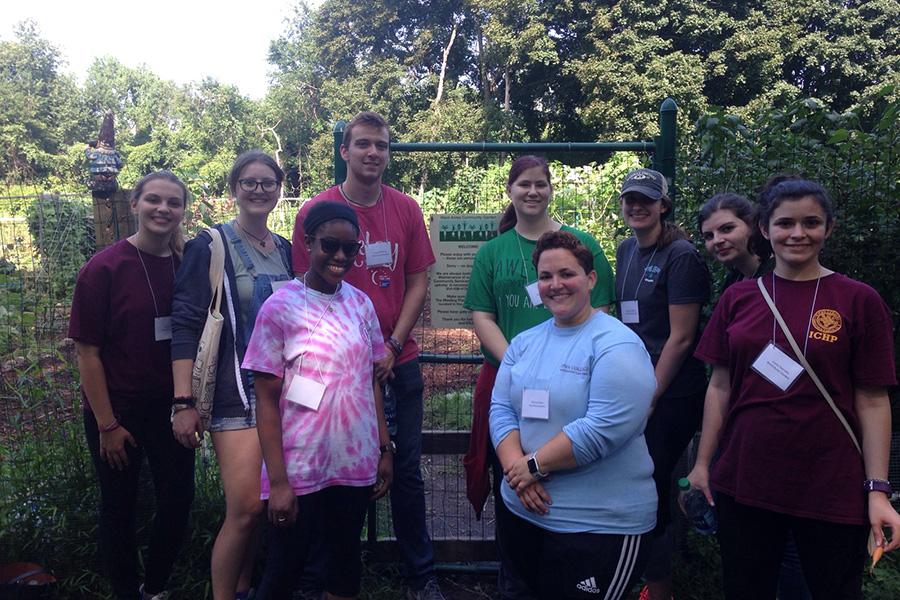 Students and staff pose for a photo during a service project.