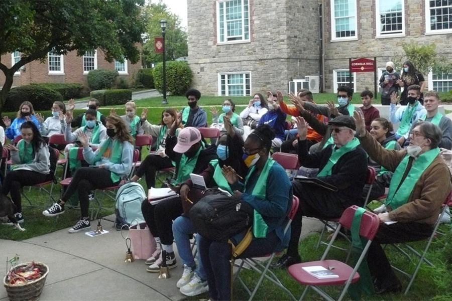 People raise their hands in prayer during St. Francis Day.