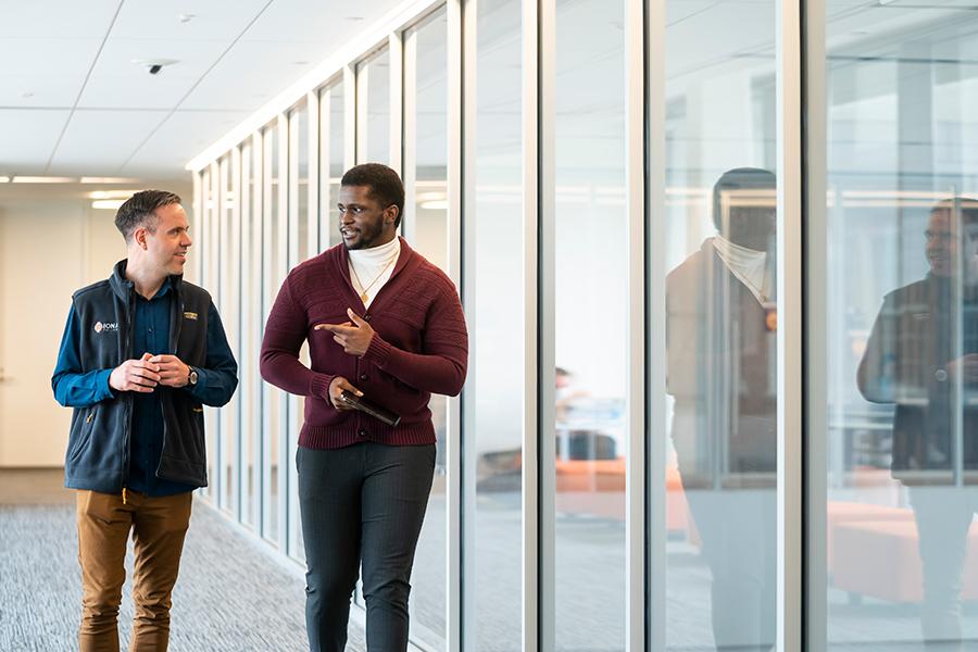 Two health care management students walk down the hallway of the LSB.