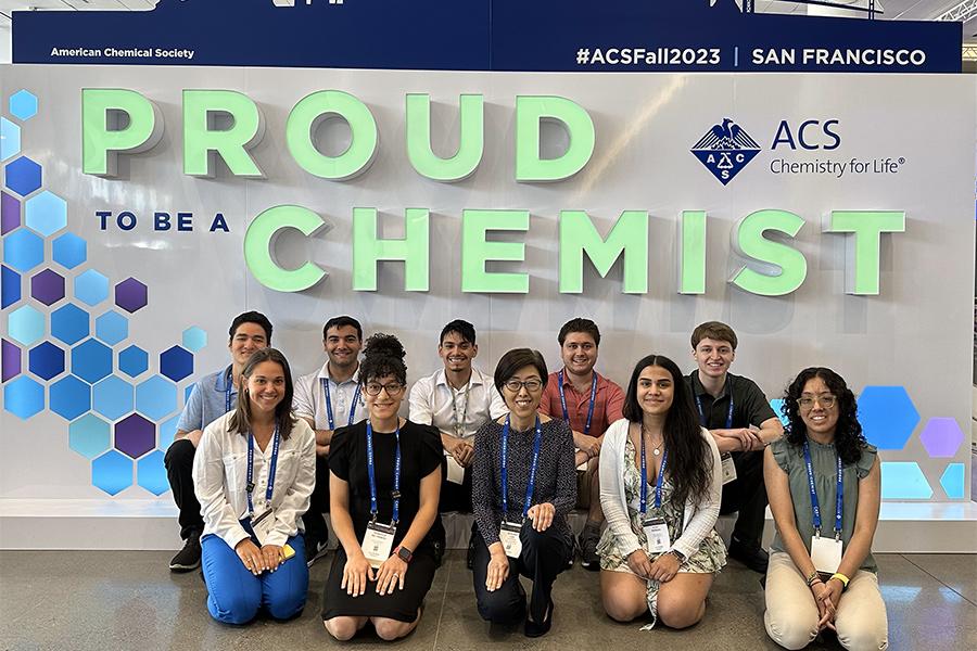 ACS SF Fall 2023 participants in fron the Proud to be a Chemist backdrop.