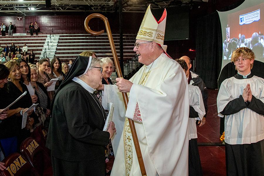 Cardinal Dolan blessing a nun at the 2023 Archdiocese Spirituality Day.