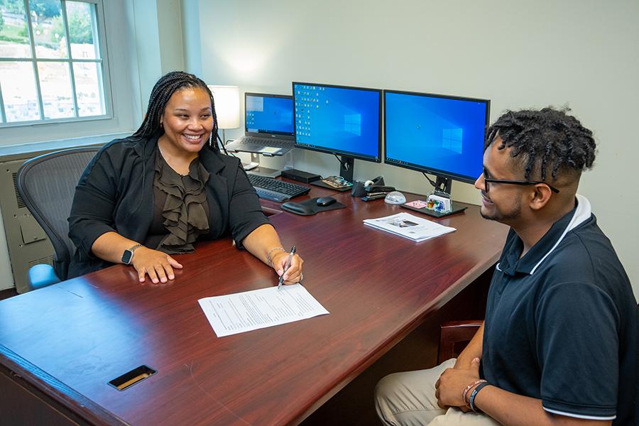 Darelle works with a student in career development.