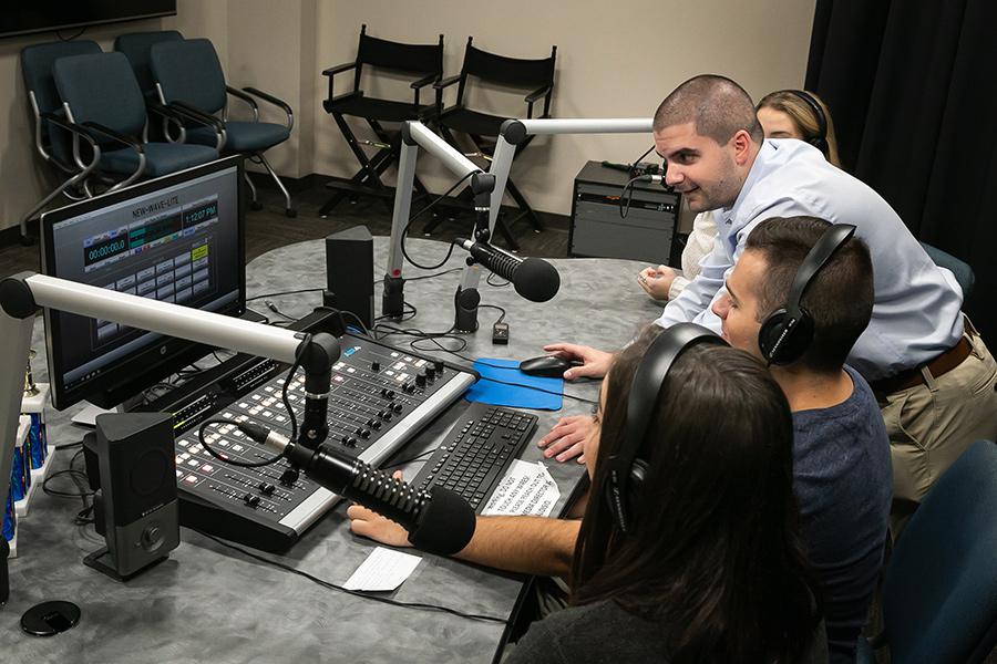 Joe teaching students in the podcast studio.