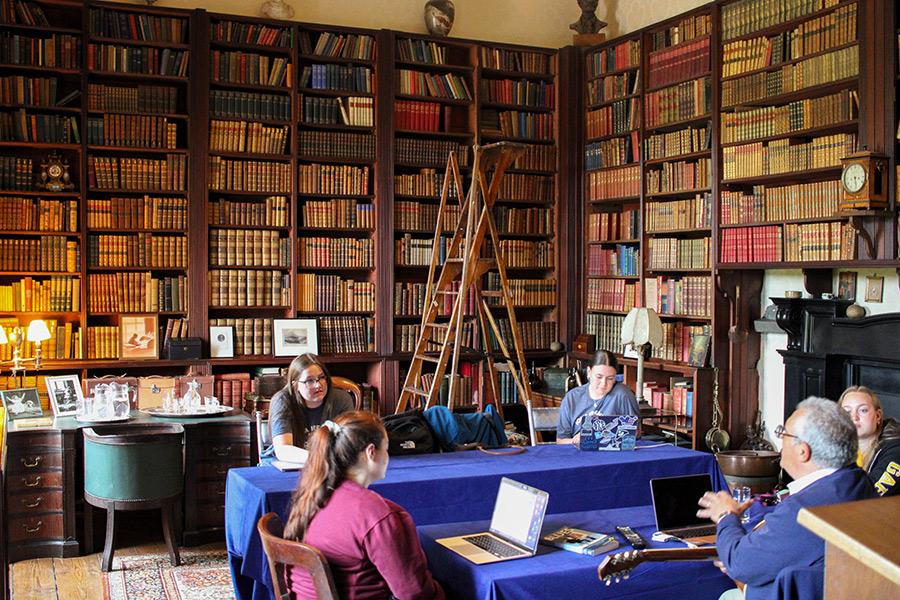 A class in Westport House in a room full of books.
