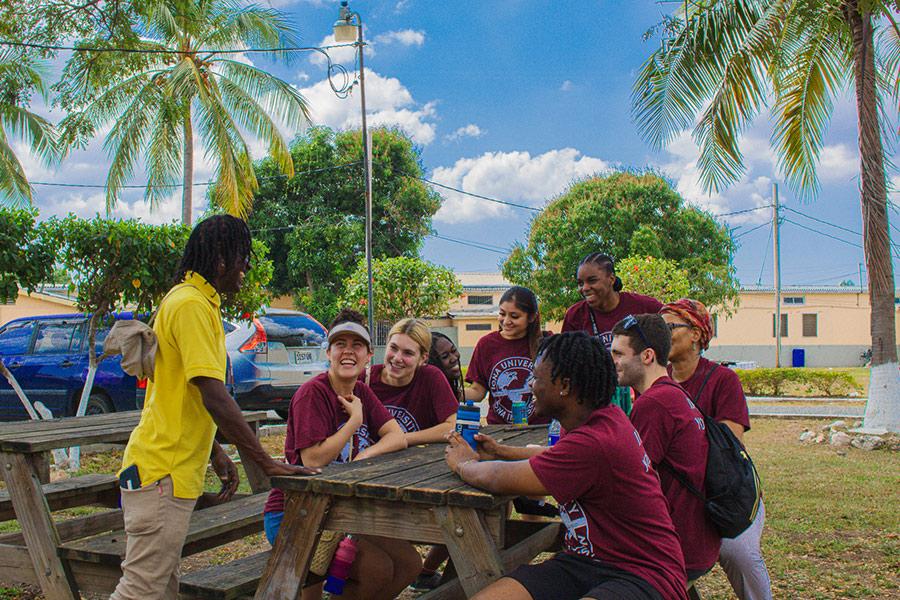 Iona in Mission students at a picnic table in Jamaica.