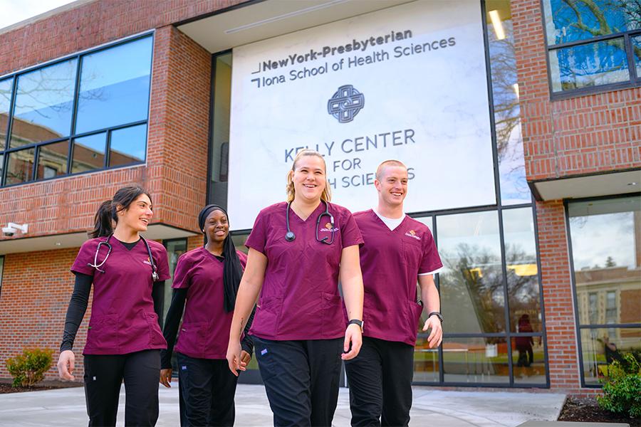 Nursing students walk near the Kelly Center for Health Sciences.