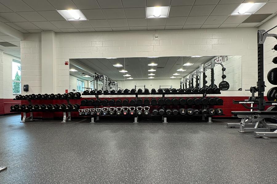 The dumbbell and kettleball rack in the weight room.