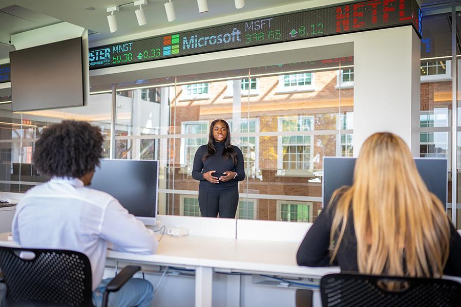 A student gives a presentation on the trading floor.