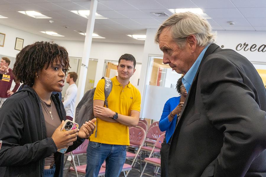 Jim Hynes speaks with a student.