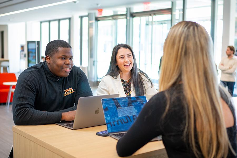 Students study together in the atrium in the LaPenta School of Business.