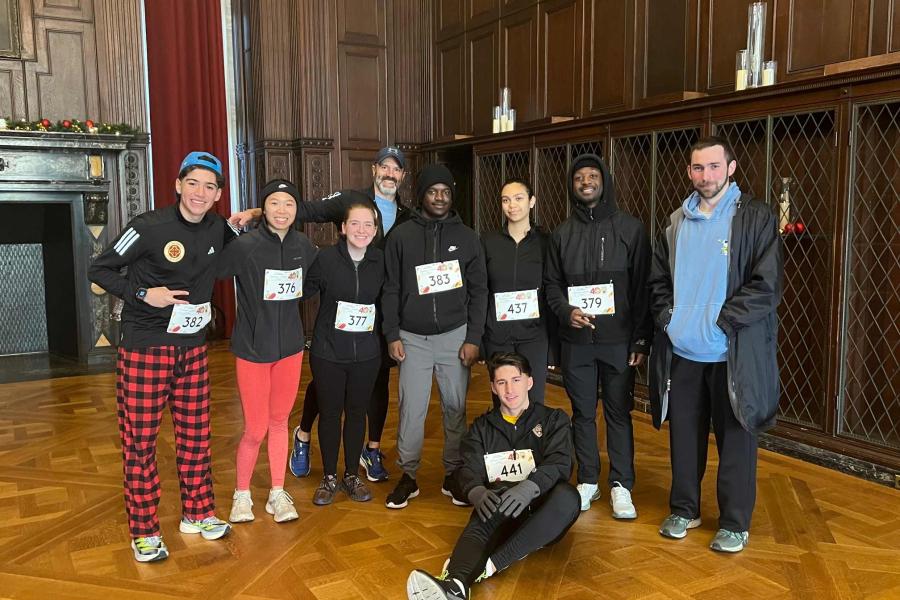 running club at Jingle Bell 5k race at Manhatanville University sitting with award