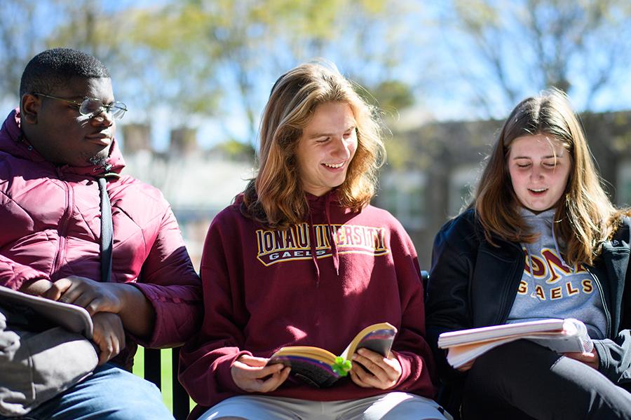 Students study on a sunny day and smile.