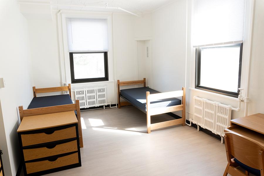 A room in Bohm Hall with beds and windows.