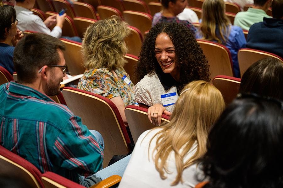 Audience members talk at the conference.