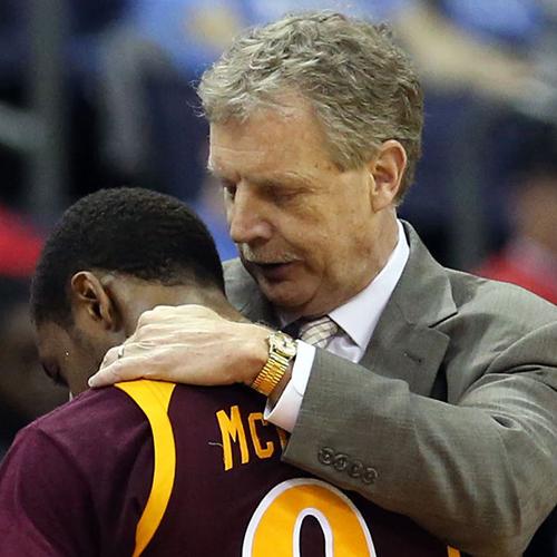 Tim Cluess comforts a basketball player during a game.