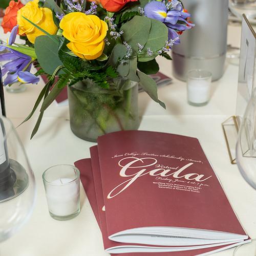Programs and flowers on the table at the 2021 Gala.