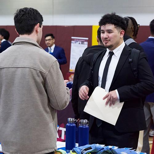 A student in a suit at the career fair.