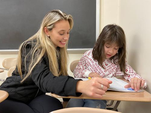 Amanta Krasniqi ’22, an adolescent education major at Iona University, reads with Valentina Oroco, a third grader at William B. Ward Elementary School in New Rochelle.