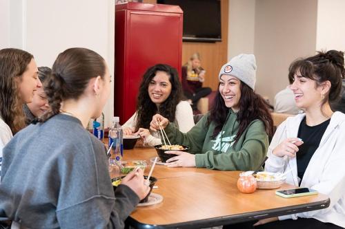 Students eat lunch and smile in Vitanza.