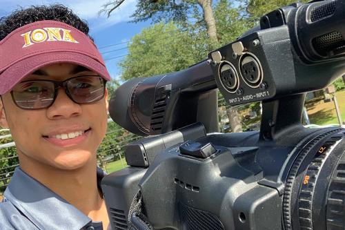 A student working the ESPN camera on campus.