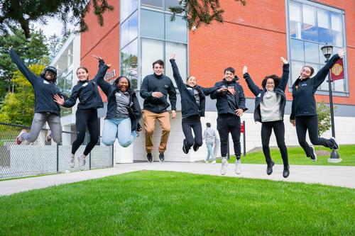 Students jumping in the air outside of the LSB.