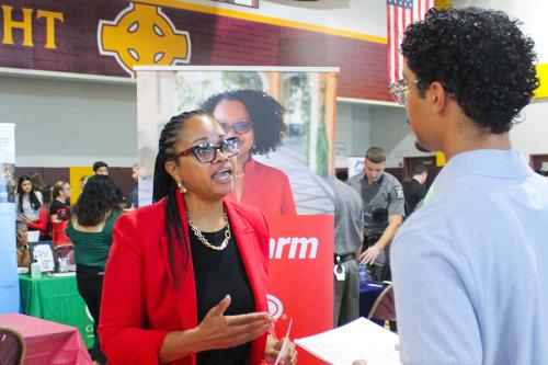 A student talks with a representative from State Farm at the Career Fair.