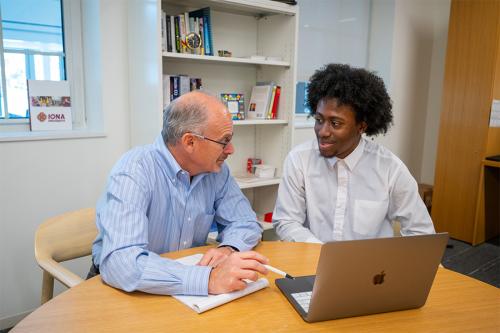 John DeMelis working with a student.