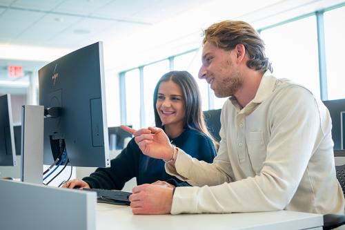 Two management students study in the LaPenta School of Business.