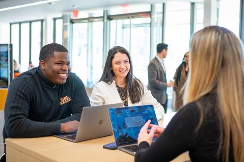 Marketing students work in the LSB atrium.