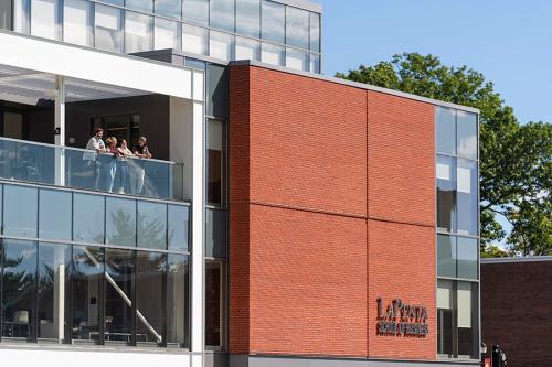 Students relax on the terrace of the LaPenta School of Business.