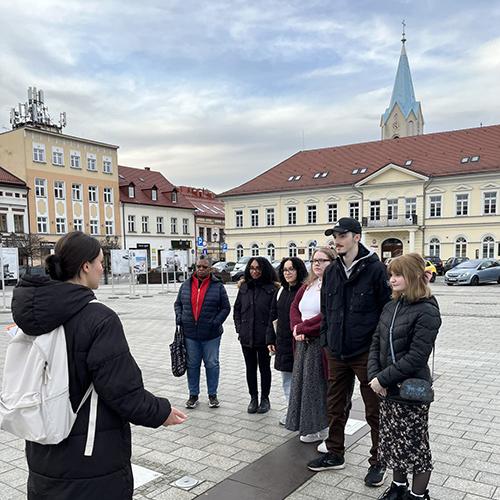 Students and faculty visiting a market square in Oświęcim, Poland.