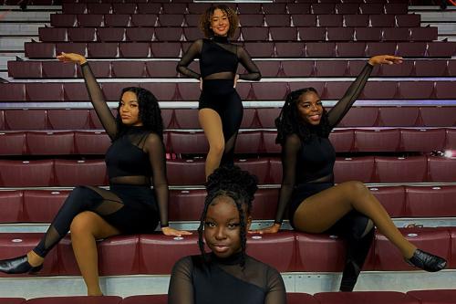 Four members of the BSU dance team in the Hynes Arena.