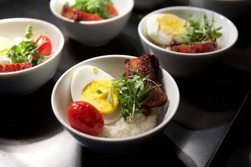 A delicious dish consisting of egg, tomato, salmon and rice.