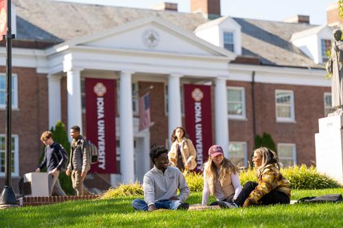 Three students enjoy the McSpedon quad on a sunny day.