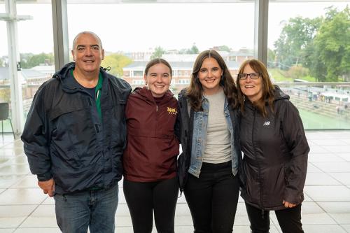 An Iona family of four in the atrium of LSB.