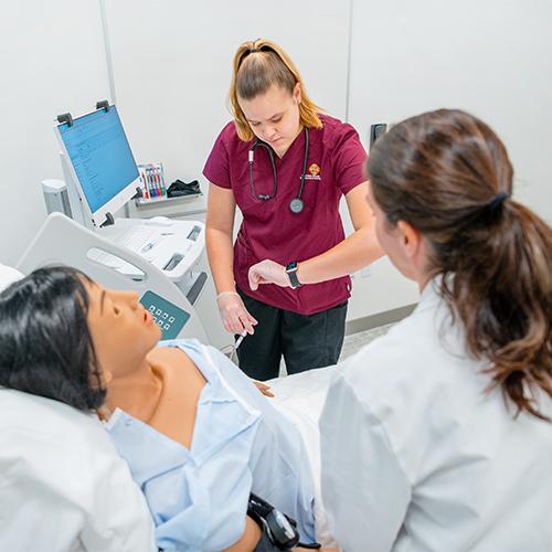 A nursing student practices reading blood pressure.