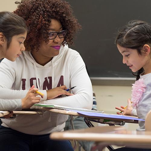 An education student practices student teaching in the classroom.