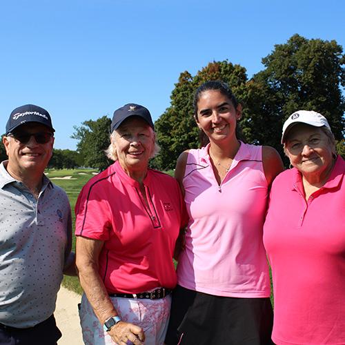 Four alumni at the 2024 Wingedfoot Golf outing smile broadly.