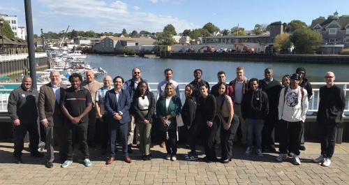 The 2024 WIN City Labs Port Chester Project members and Iona Students in front of the harbor.