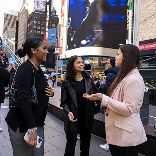 Students talk in Times Square.